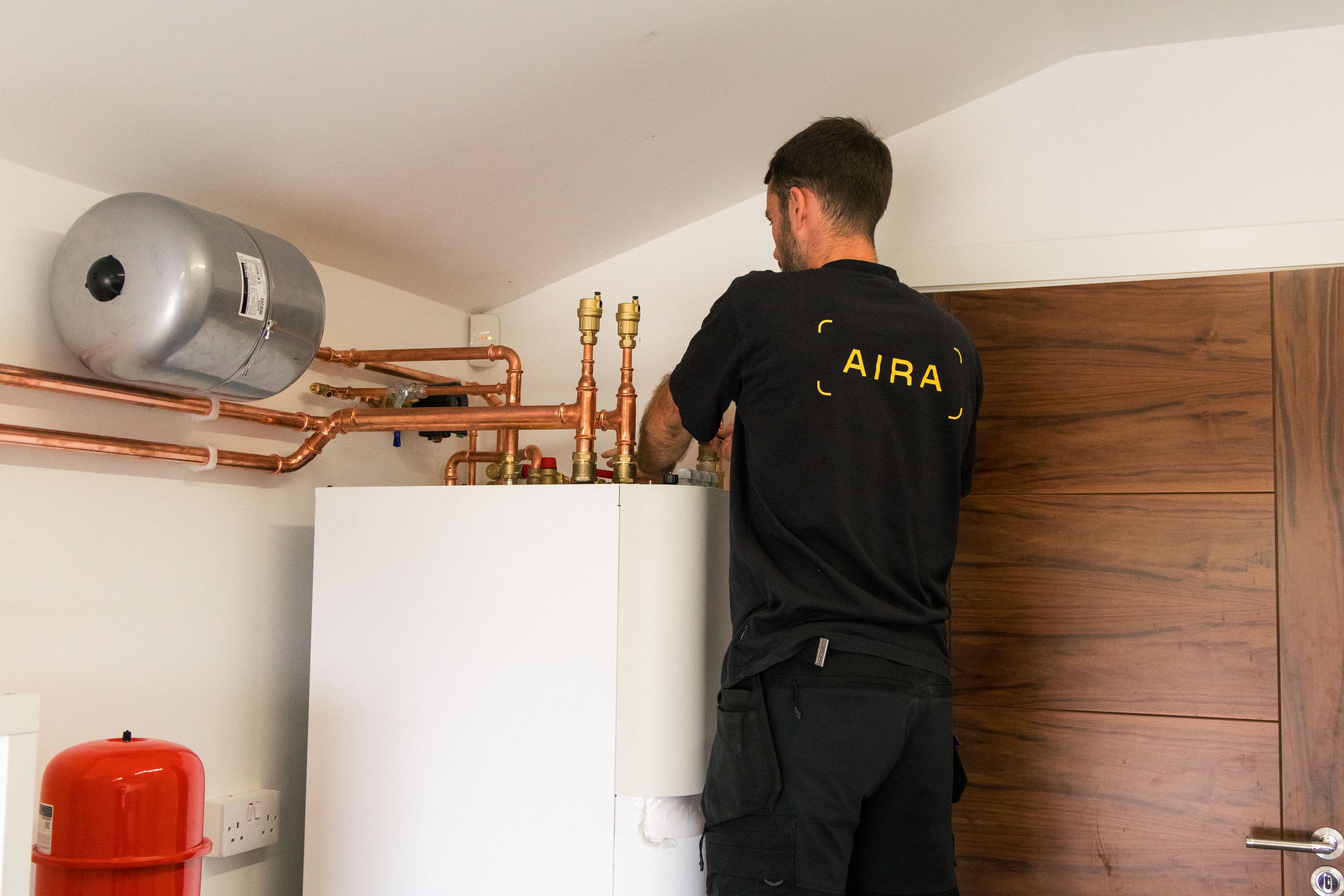 Aira technician installing the Aira all-in-one heat pump indoor unit in a customer's garage
