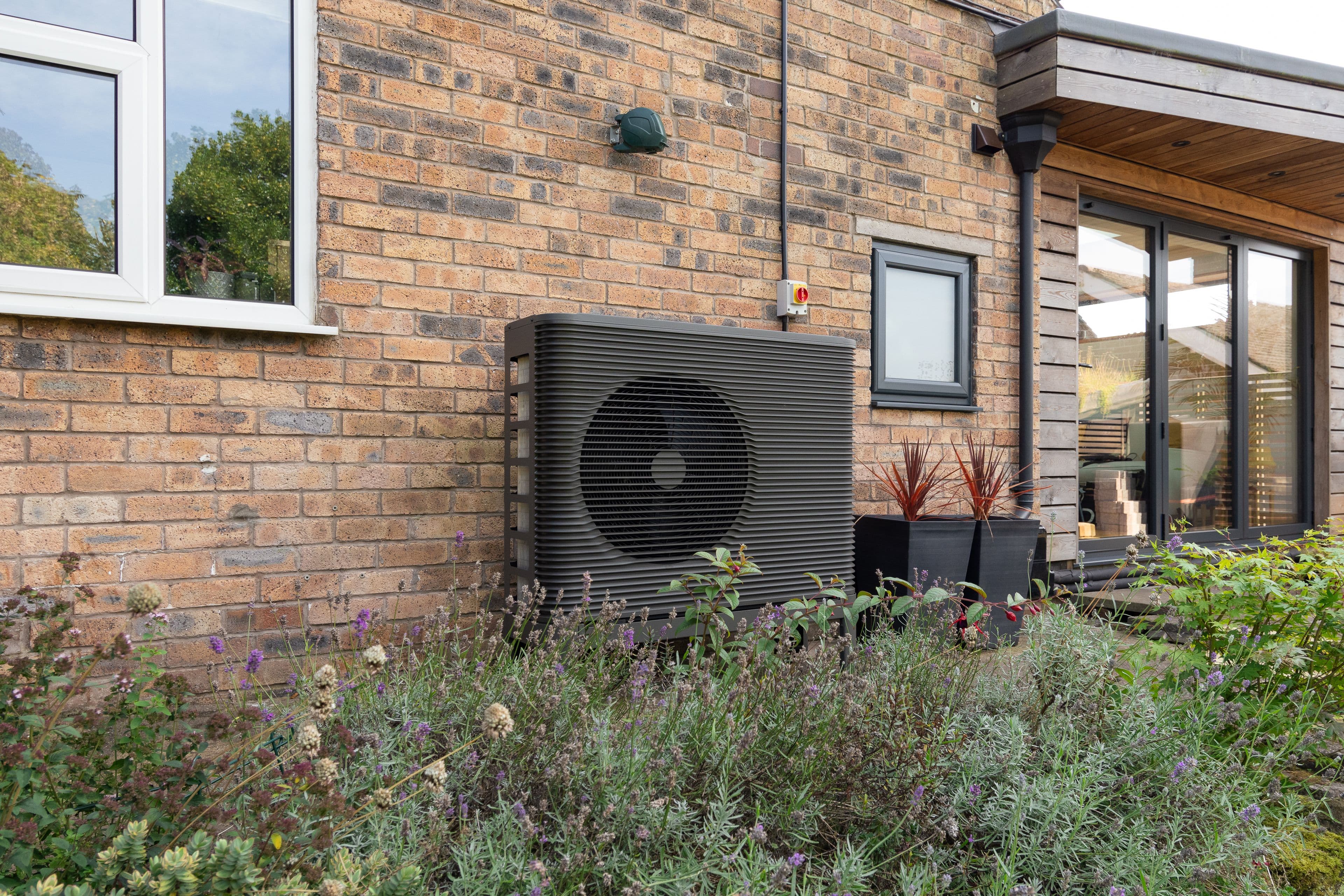 Picture of an Aira Heat Pump outside someone's home