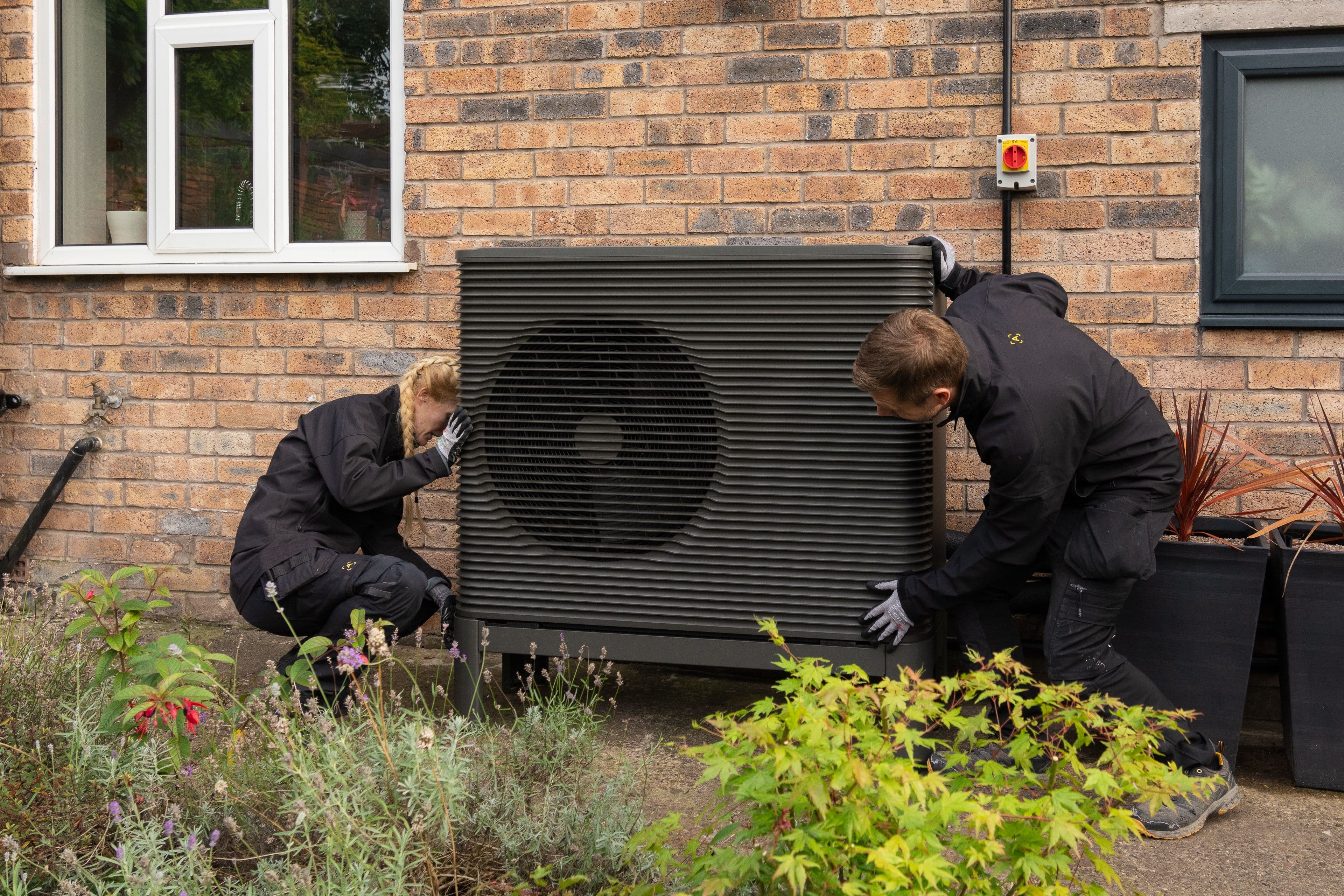 Two Aira Technicians installing an Aira Heat Pump 