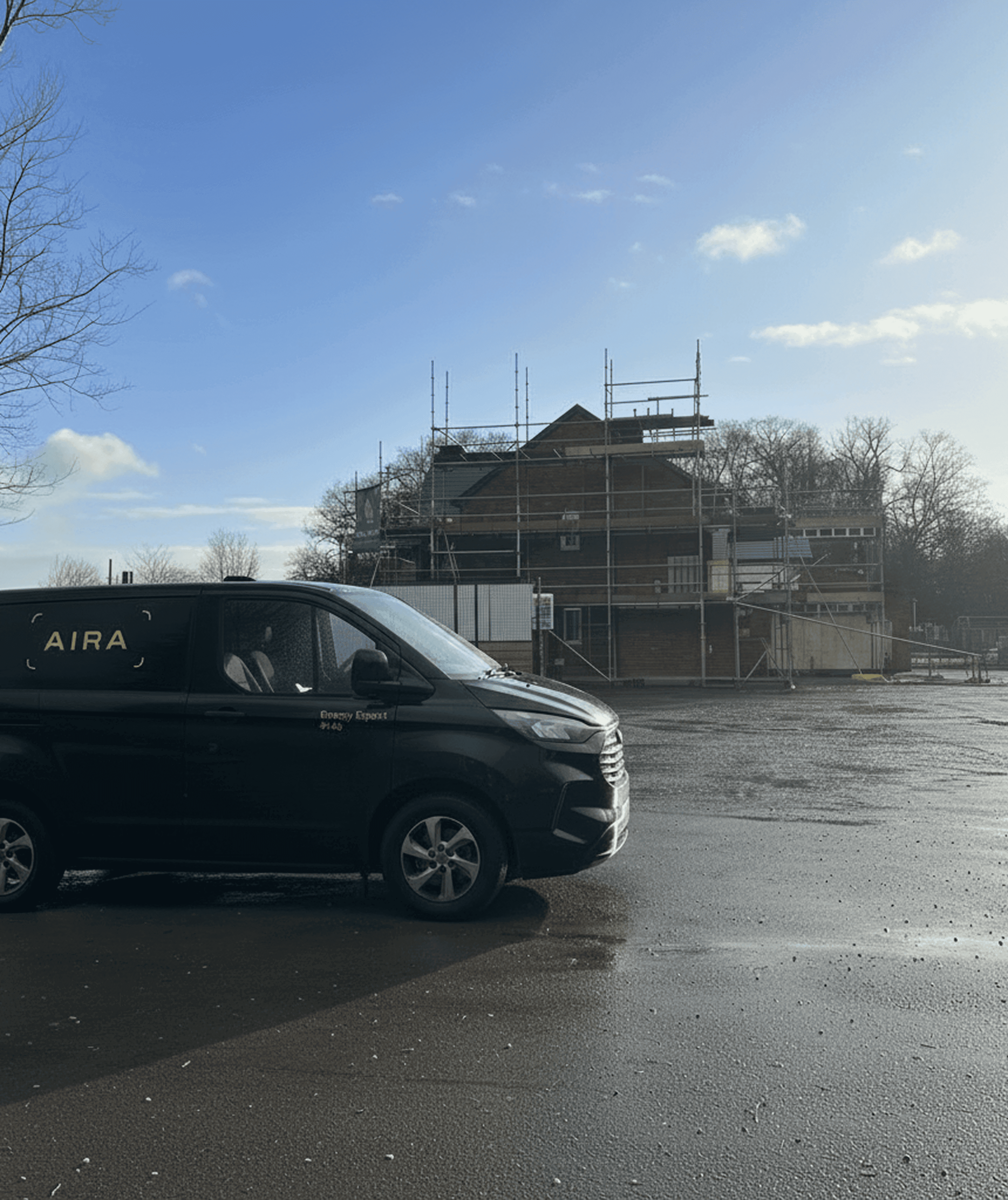 Black Aira van outside a housing development 