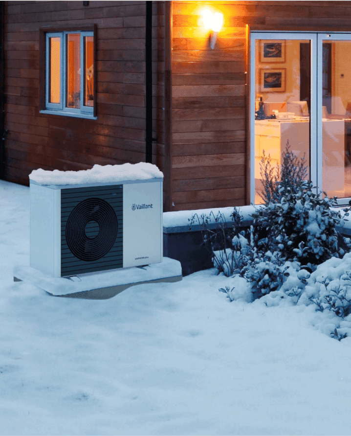 Picture of a vaillant heat pump in the snow outside a home