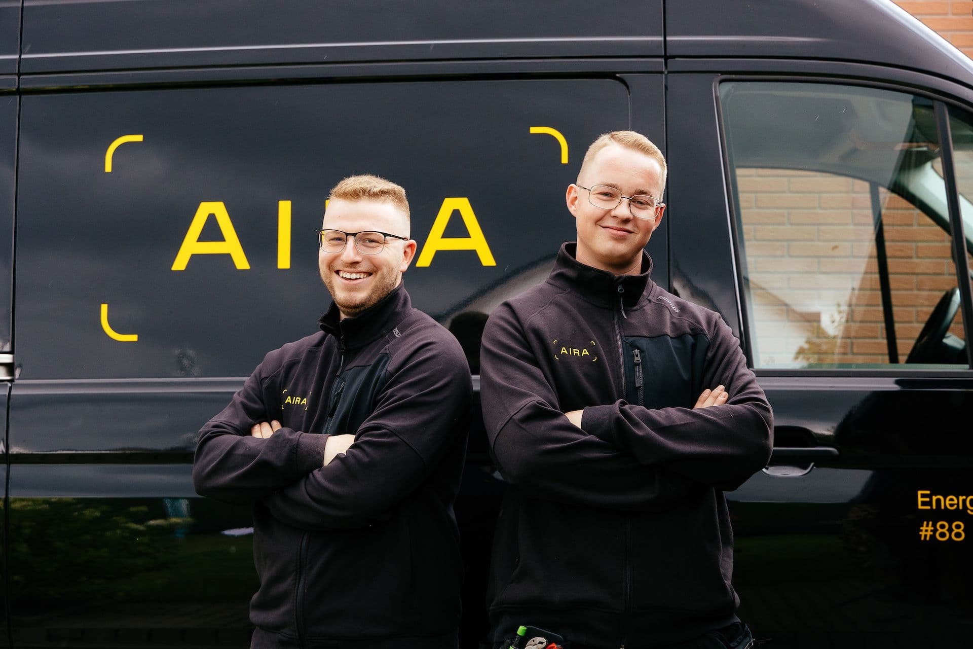 Two Aira technichians standing in front of an Aira van
