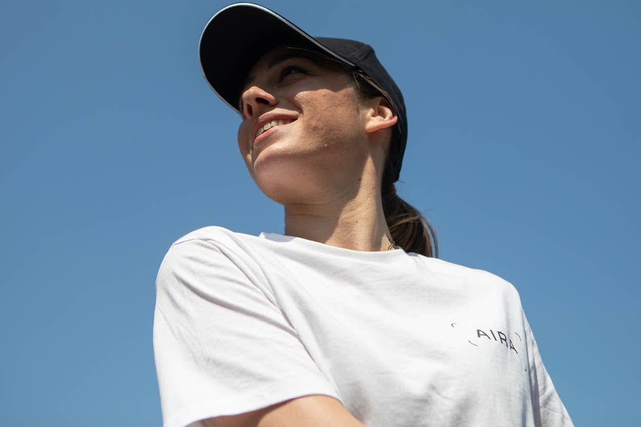 Aira employee wearing a white branded t-shirt and a cap