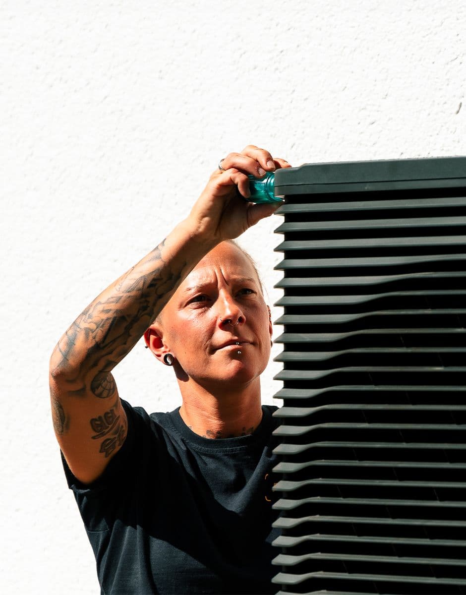 Aira Clean Energy Technician installing a heat pump