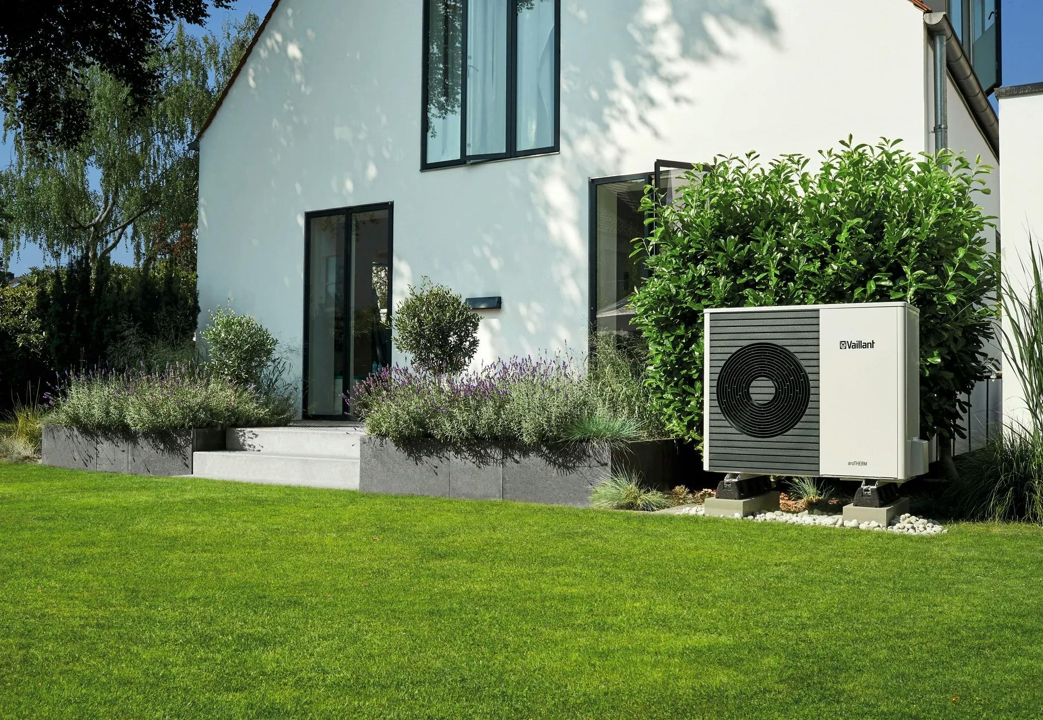 `Air to water Vaillant aroTherm heat pump in the garden of a white house