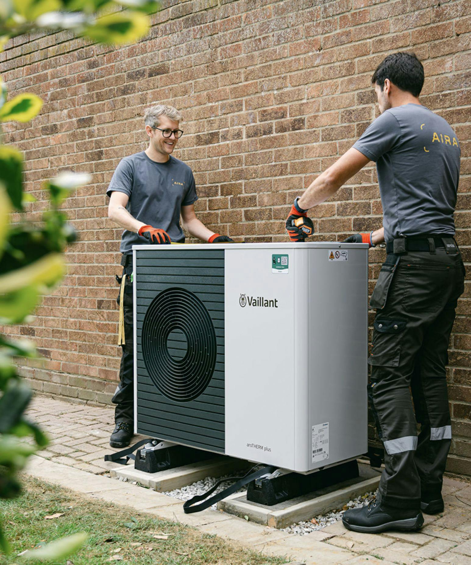 Two Aira heat pump installers with an air to water Vaillant heat pump