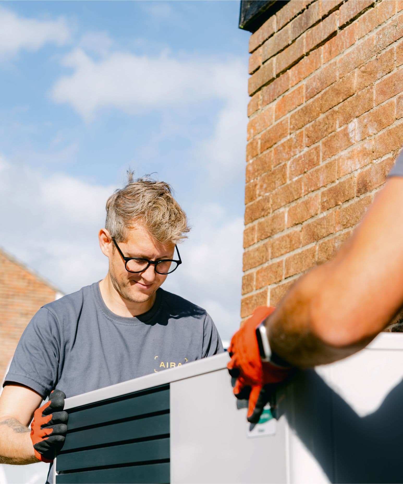Aira heat pump installer moving an air to water heat pump