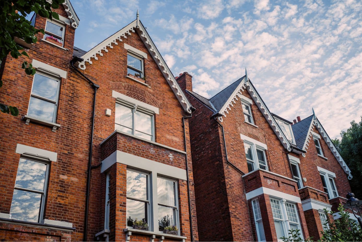 Tall, red brick houses with sky in the background