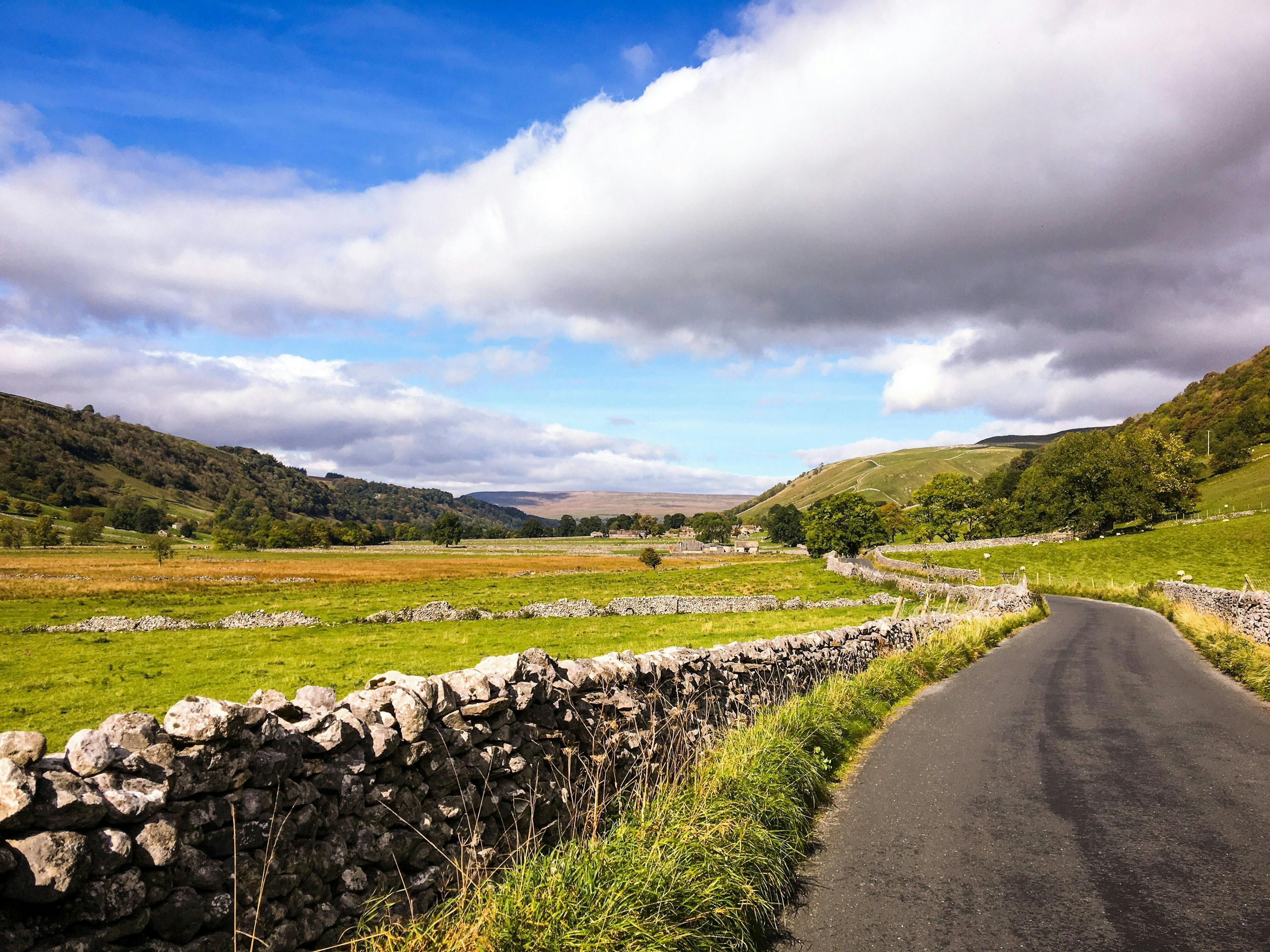 Road with dry stone walls on either side in Skipton, North Yorkshire