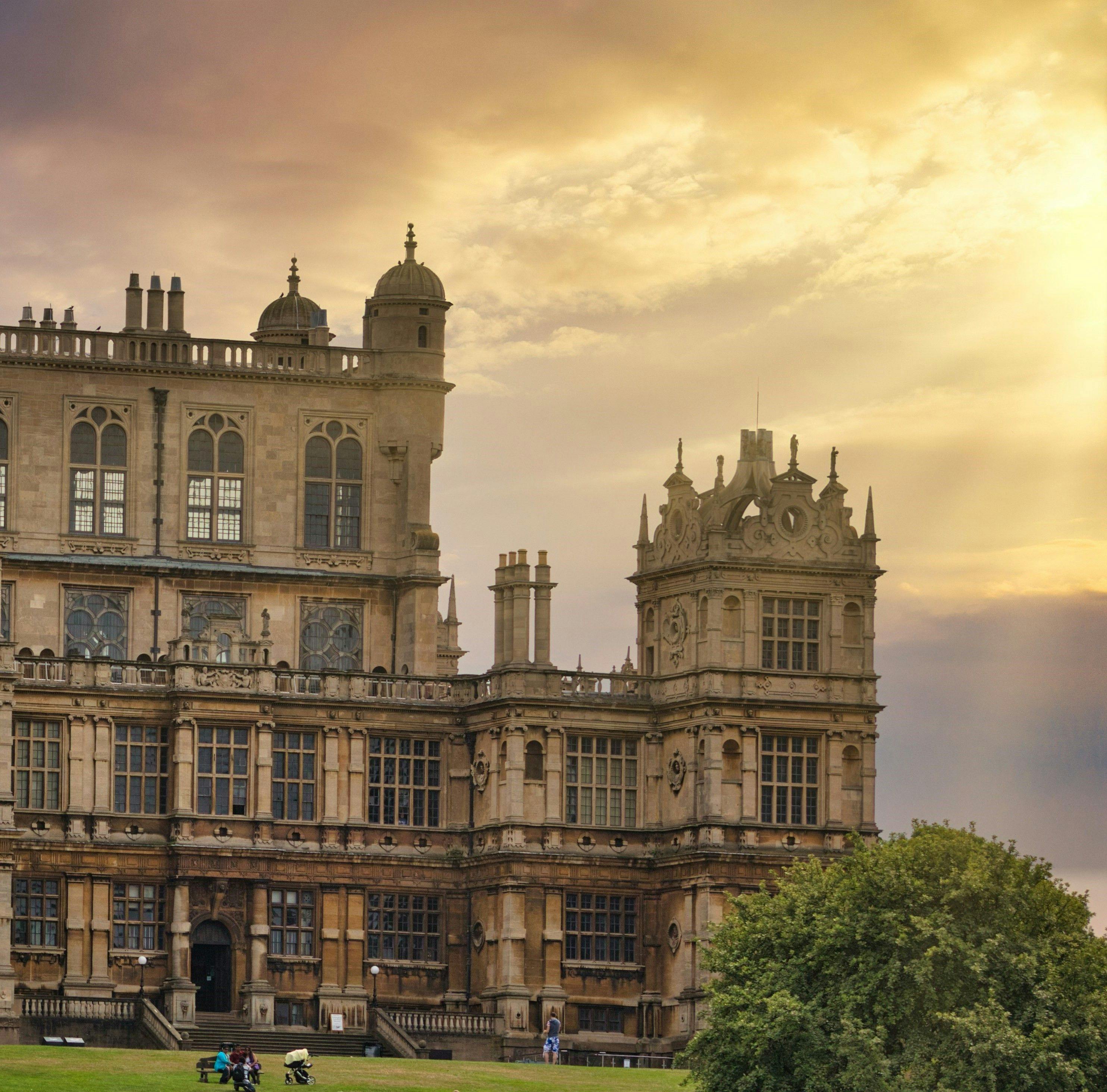 Wollaton Hall in Wollaton Park, Nottingham with the sun breaking through the clouds